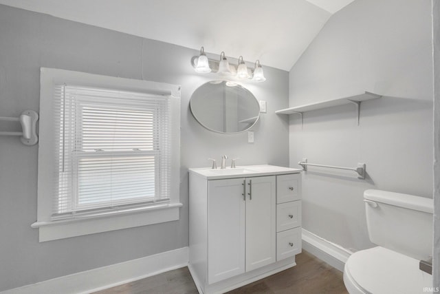 bathroom with toilet, baseboards, lofted ceiling, and wood finished floors