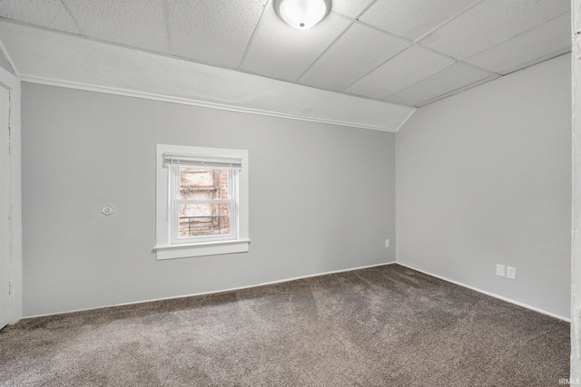 spare room with carpet floors, vaulted ceiling, and a paneled ceiling
