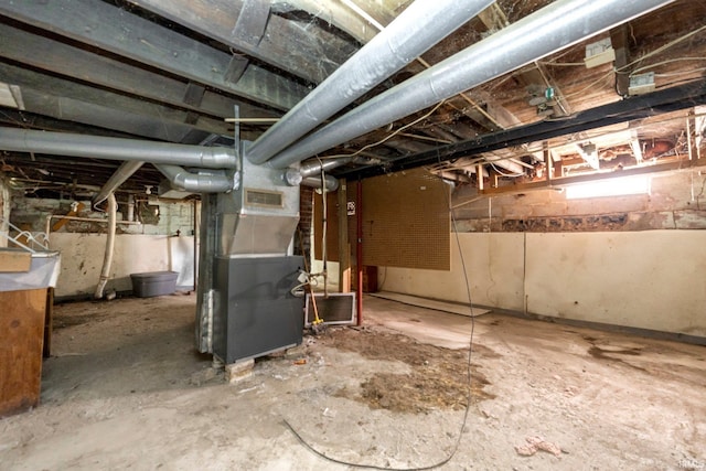 unfinished below grade area featuring heating unit
