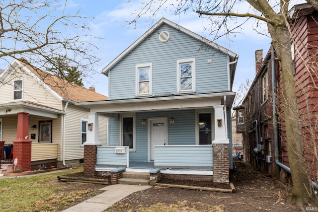american foursquare style home featuring covered porch
