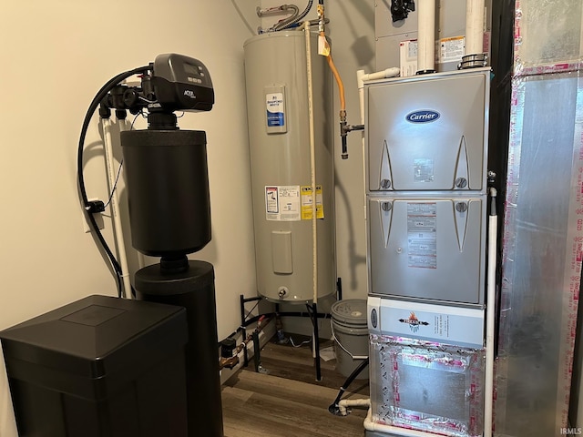 utility room featuring water heater and heating unit
