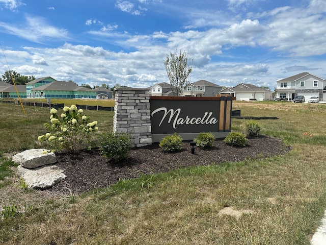 community sign with a yard and a residential view