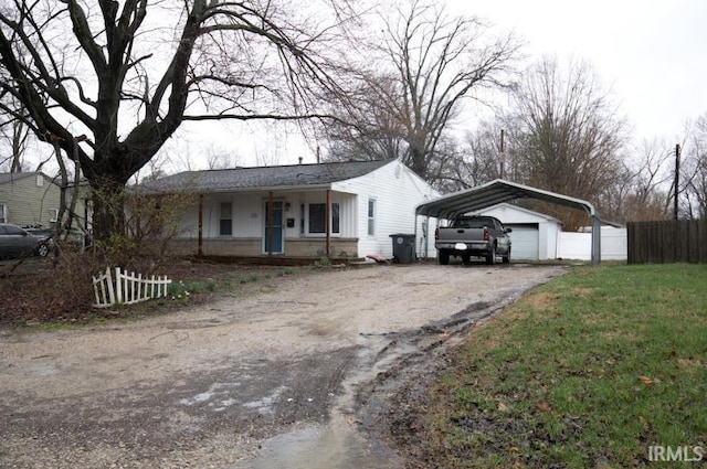 1620 Shelby Ave, Evansville, IN 47714 - ranch-style house featuring fence, aphalt driveway, a front yard, a porch, and a carport