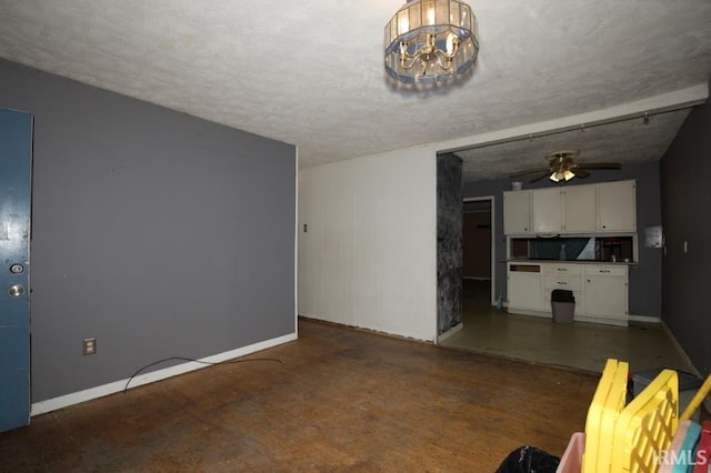 1620 Shelby Ave, Evansville, IN 47714 - unfurnished living room with baseboards, concrete floors, a textured ceiling, and a ceiling fan
