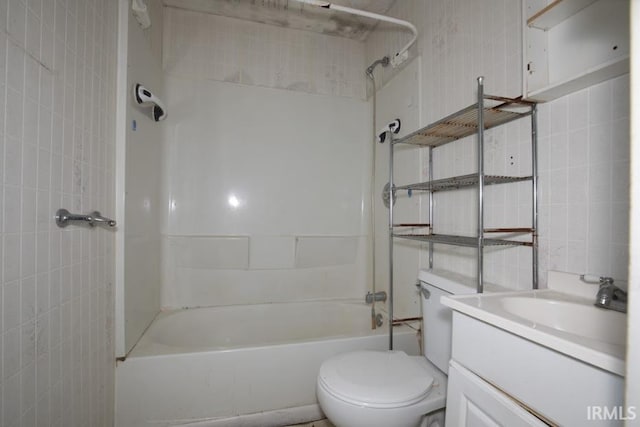 1620 Shelby Ave, Evansville, IN 47714 - bathroom with toilet, vanity, shower / bathtub combination, and tile walls