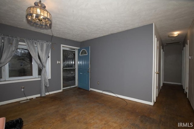 1620 Shelby Ave, Evansville, IN 47714 - interior space featuring baseboards, a chandelier, wood finished floors, and a textured ceiling