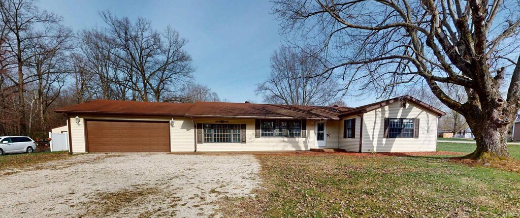 4120 N Prides Creek Dr, Petersburg, IN 47567 - ranch-style home featuring a front lawn, driveway, and an attached garage