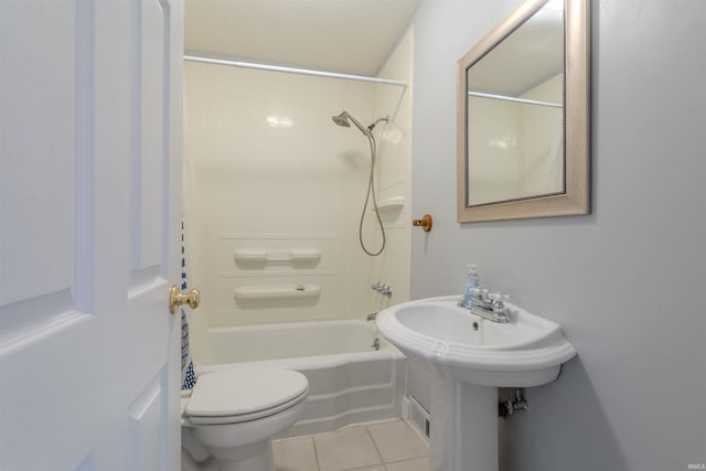 bathroom featuring shower / tub combination, tile patterned floors, and toilet