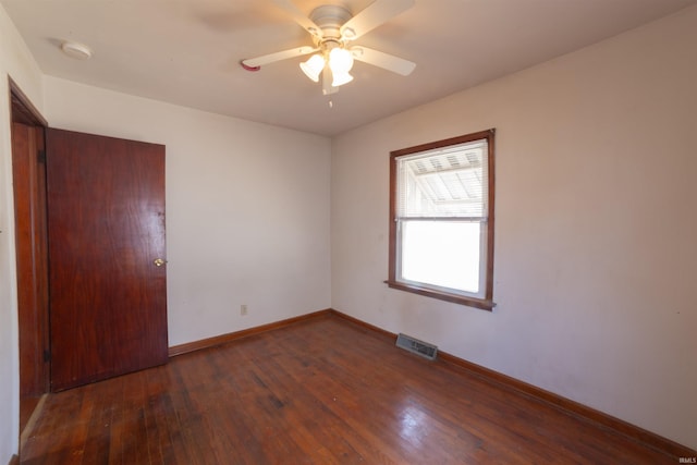unfurnished room featuring baseboards, ceiling fan, visible vents, and wood-type flooring