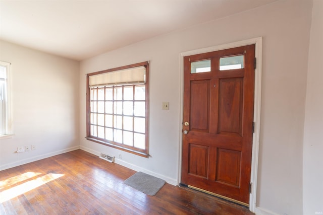 entryway featuring dark wood-style floors, baseboards, and visible vents