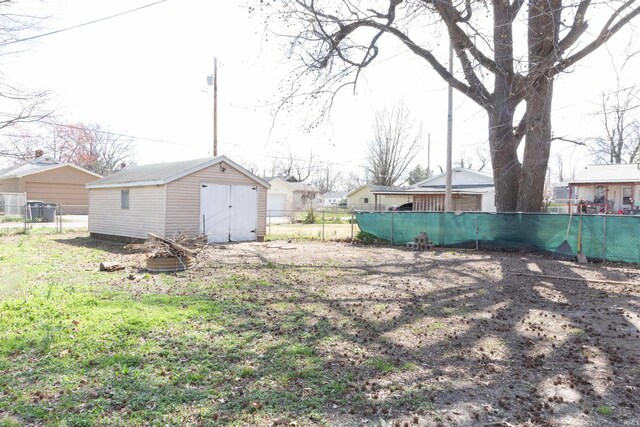 view of yard with an outbuilding, a shed, and fence
