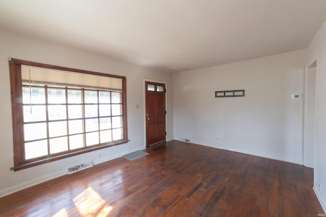 entrance foyer with dark wood-style flooring, baseboards, and visible vents