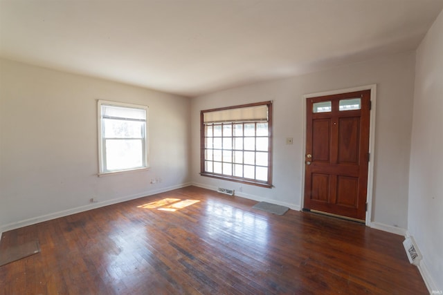 entrance foyer featuring baseboards, visible vents, and hardwood / wood-style flooring