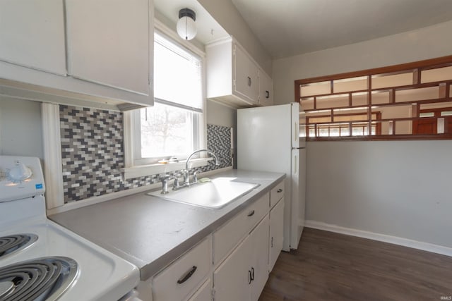 kitchen with backsplash, a sink, white cabinetry, and white appliances