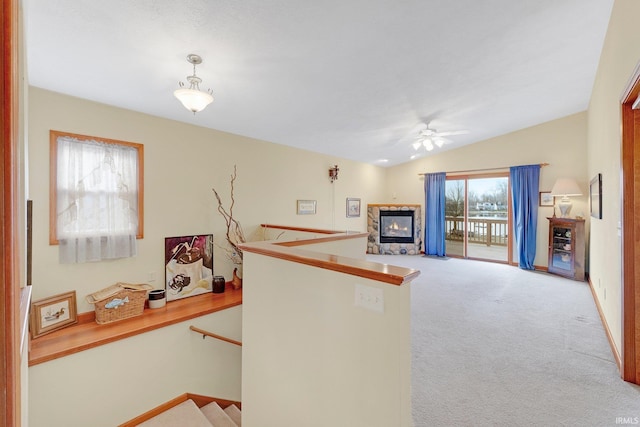 5540 N Willow Ave, Columbia City, IN 46725 - kitchen featuring a ceiling fan, decorative light fixtures, carpet floors, a glass covered fireplace, and vaulted ceiling