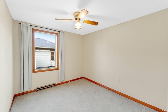 5540 N Willow Ave, Columbia City, IN 46725 - unfurnished room with light carpet, baseboards, visible vents, and ceiling fan