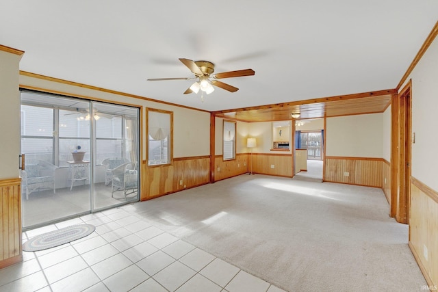 5540 N Willow Ave, Columbia City, IN 46725 - unfurnished living room featuring a wainscoted wall, ceiling fan, wood walls, and light colored carpet