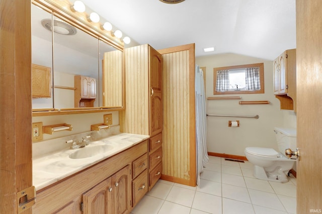 5540 N Willow Ave, Columbia City, IN 46725 - full bath with vaulted ceiling, toilet, tile patterned flooring, baseboards, and visible vents