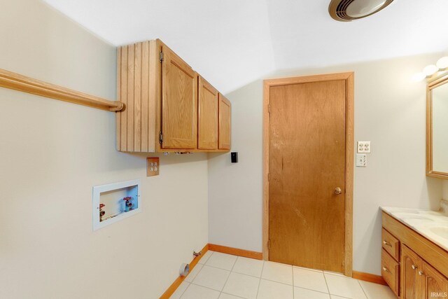 5540 N Willow Ave, Columbia City, IN 46725 - laundry area featuring washer hookup, cabinet space, baseboards, and light tile patterned floors