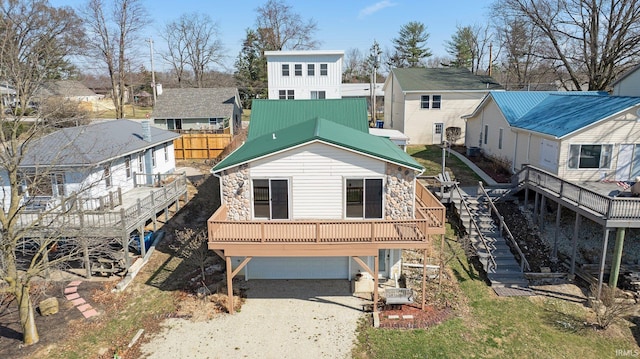 5540 N Willow Ave, Columbia City, IN 46725 - back of property with driveway, stairs, stone siding, and a residential view