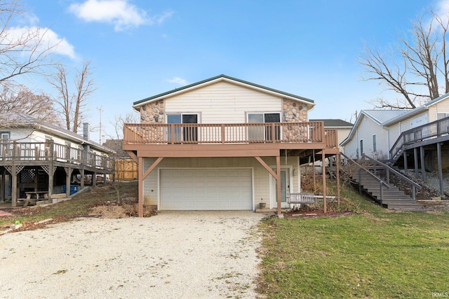 5540 N Willow Ave, Columbia City, IN 46725 - view of front of home with an attached garage, stairway, a deck, a front yard, and driveway