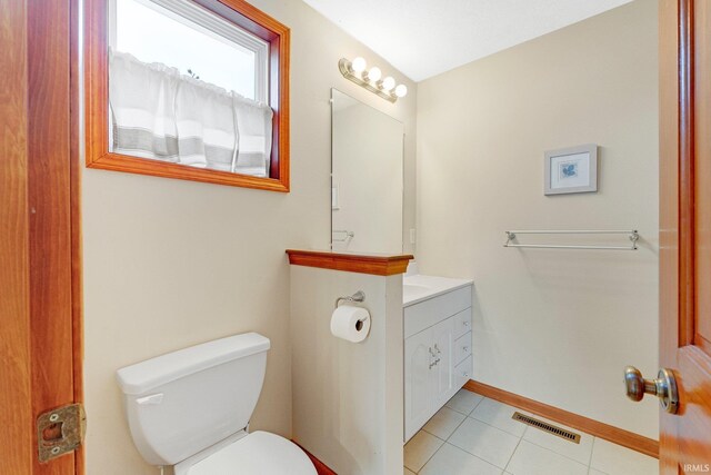 5540 N Willow Ave, Columbia City, IN 46725 - half bathroom featuring toilet, vanity, tile patterned flooring, baseboards, and visible vents