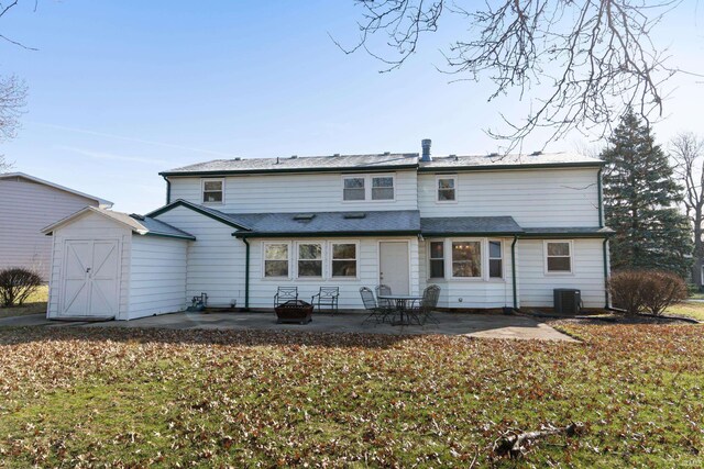 3323 Kiowa Ct, Fort Wayne, IN 46815 - rear view of property with a patio area, an outdoor fire pit, a storage unit, an outdoor structure, and central AC unit