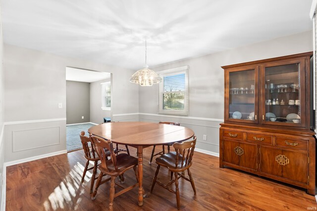 3323 Kiowa Ct, Fort Wayne, IN 46815 - dining area with wainscoting, a notable chandelier, and wood finished floors