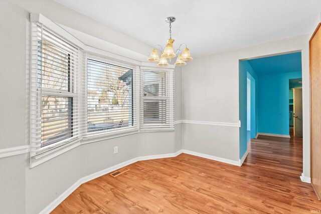 3323 Kiowa Ct, Fort Wayne, IN 46815 - unfurnished dining area featuring light wood-style flooring, a notable chandelier, baseboards, and visible vents
