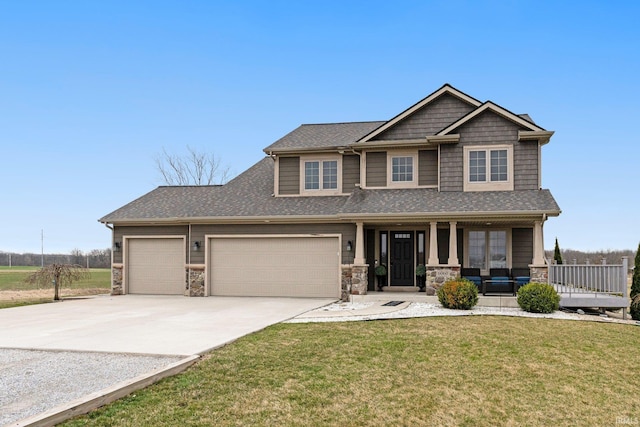 craftsman-style house featuring a front yard, a porch, stone siding, and concrete driveway