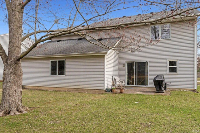 6027 Old Brook Dr, Fort Wayne, IN 46835 - rear view of house featuring roof with shingles, a patio area, and a lawn