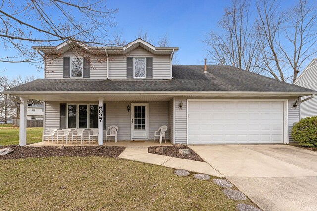 6027 Old Brook Dr, Fort Wayne, IN 46835 - traditional home with a garage, a front lawn, driveway, covered porch, and a shingled roof
