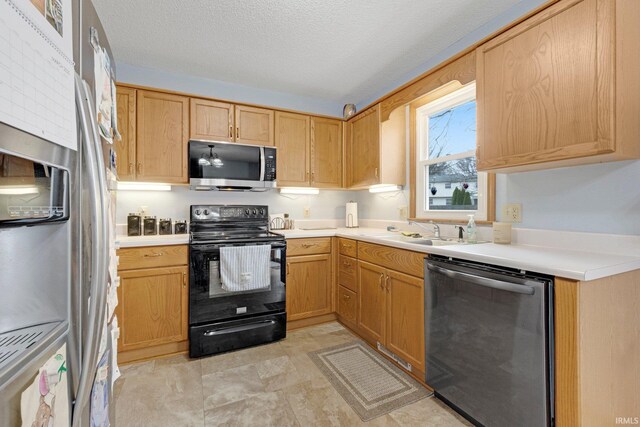 6027 Old Brook Dr, Fort Wayne, IN 46835 - kitchen featuring a textured ceiling, light countertops, a sink, and appliances with stainless steel finishes