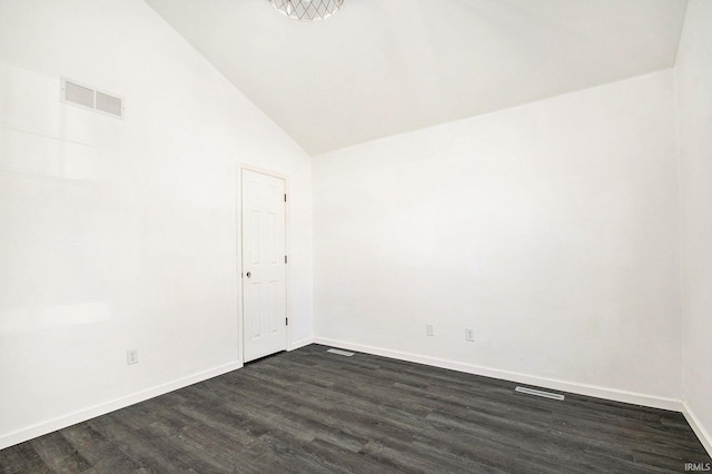 empty room with dark wood-type flooring, baseboards, visible vents, and vaulted ceiling