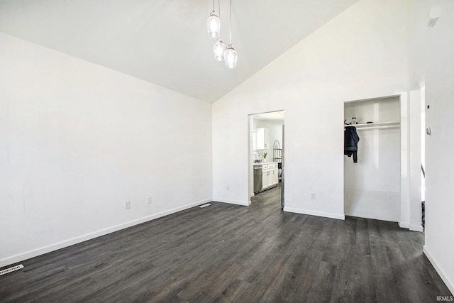 unfurnished bedroom with baseboards, high vaulted ceiling, a closet, and dark wood-type flooring