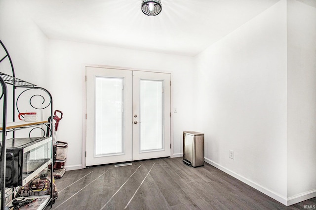 foyer entrance featuring dark wood finished floors, baseboards, and french doors