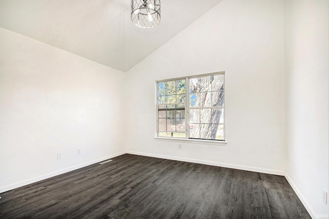 unfurnished room featuring high vaulted ceiling, dark wood-type flooring, and baseboards
