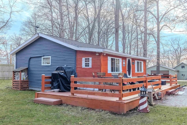 back of house with a yard and a deck