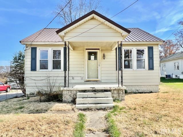5011 Big Cynthiana Rd, Evansville, IN 47720 - bungalow-style home with a front lawn and metal roof
