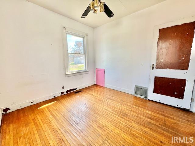5011 Big Cynthiana Rd, Evansville, IN 47720 - spare room featuring baseboards, visible vents, a ceiling fan, and hardwood / wood-style floors