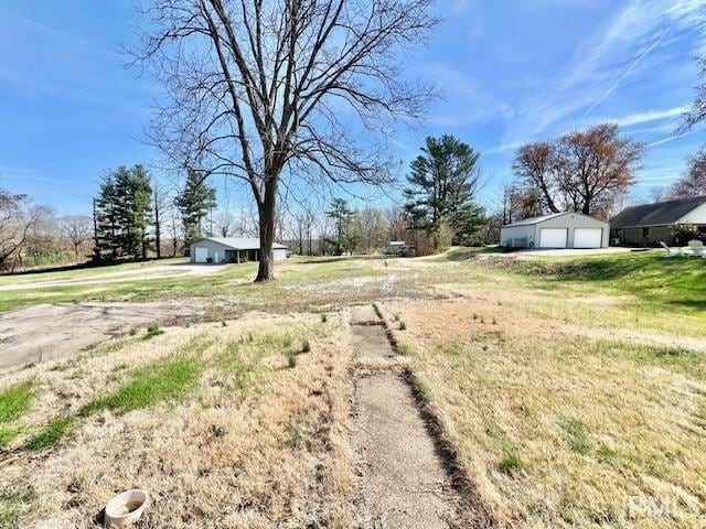 5011 Big Cynthiana Rd, Evansville, IN 47720 - view of yard featuring driveway, an outbuilding, and a garage