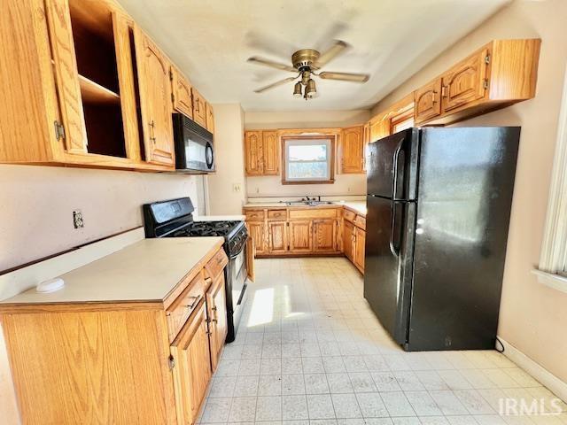 5011 Big Cynthiana Rd, Evansville, IN 47720 - kitchen with light countertops, baseboards, a sink, a ceiling fan, and black appliances