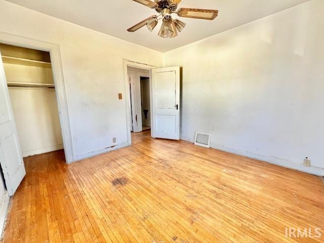 5011 Big Cynthiana Rd, Evansville, IN 47720 - unfurnished bedroom with a closet, visible vents, baseboards, ceiling fan, and light wood-style floors