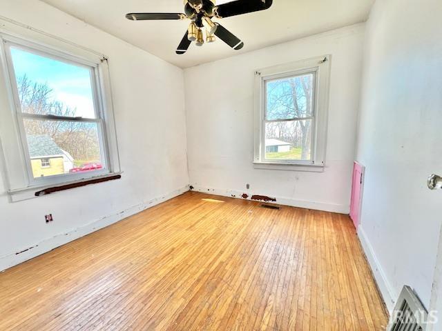 5011 Big Cynthiana Rd, Evansville, IN 47720 - spare room featuring baseboards, visible vents, light wood-style floors, and a ceiling fan
