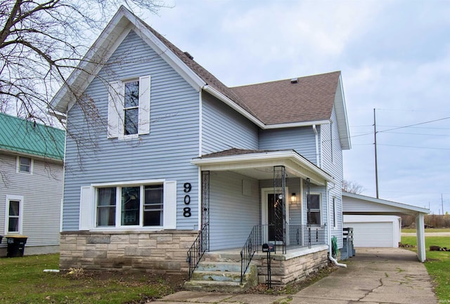 908 S Main St, Kendallville, IN 46755 - traditional home with an outdoor structure, stone siding, a garage, and roof with shingles