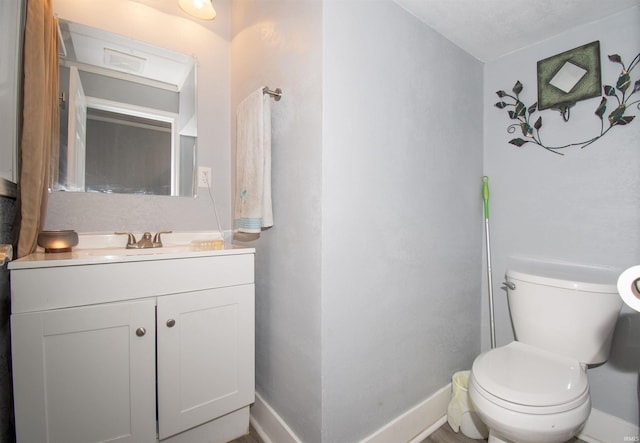 908 S Main St, Kendallville, IN 46755 - bathroom featuring toilet, vanity, and baseboards