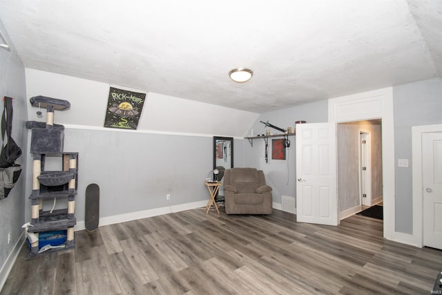 908 S Main St, Kendallville, IN 46755 - living area featuring baseboards, visible vents, wood finished floors, and vaulted ceiling