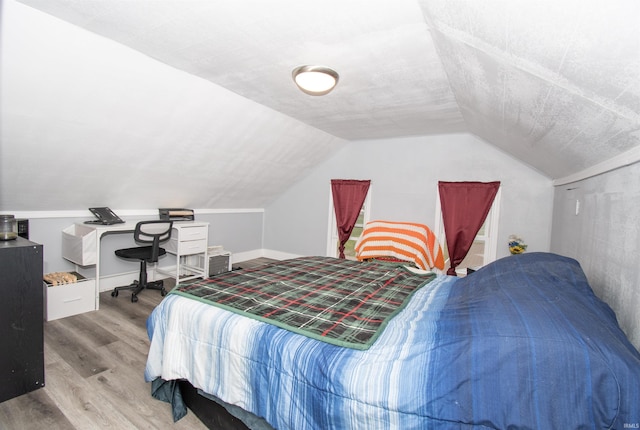 908 S Main St, Kendallville, IN 46755 - bedroom featuring lofted ceiling, light wood-style floors, and a textured ceiling