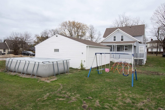 908 S Main St, Kendallville, IN 46755 - back of property with a lawn, a covered pool, and a playground
