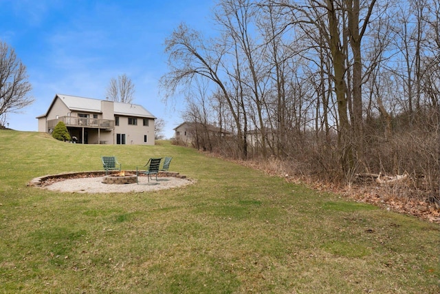 view of yard featuring an outdoor fire pit and a deck